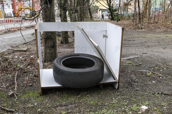 A car tyre lies in a broken kitchen cupboard, illegal waste disposal in the Berlin district of Wedding, 15.02.2024