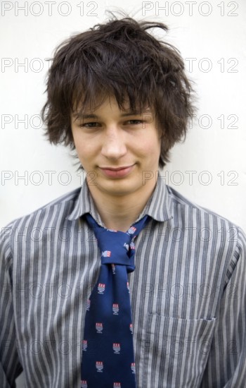 Model released head and shoulders portrait of teenage wearing shirt and tie, UK