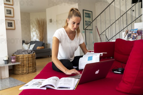 Young student learns at home, online, on her notebook