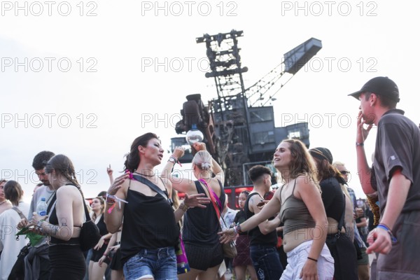 Celebrating visitors in front of excavators at the Melt Festival in Ferropolis on 12 July 2024. After a total of 27 years, the festival will take place for the last time in 2024