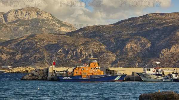 Harbour with fishing boats in front of a mountainous coast, Pigadia, town and harbour, coast guard boat, Pigadia Bay, main town, Karpathos, Dodecanese, Greek Islands, Greece, Europe