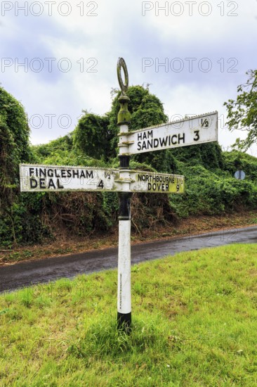 Old moss-covered signposts in the countryside, showing direction and distance to Ham, Sandwich and Deal, rainy weather, Northbourne, Kent, Dover, England, United Kingdom, Europe