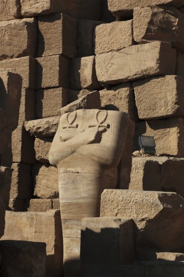 Luxor, Karnak Temple, headless statue with the symbol of the key to life, the Ankh, in the temple complex in Karnak, Africa, Upper Egypt, UNESCO World Heritage Site