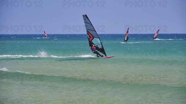 Several windsurfers glide over the blue sea under a clear sky, surfer's paradise, kitesurfer, windsurfer, Prasonisi, island in the south of Rhodes, Rhodes, Dodecanese, Greek Islands, Greece, Europe