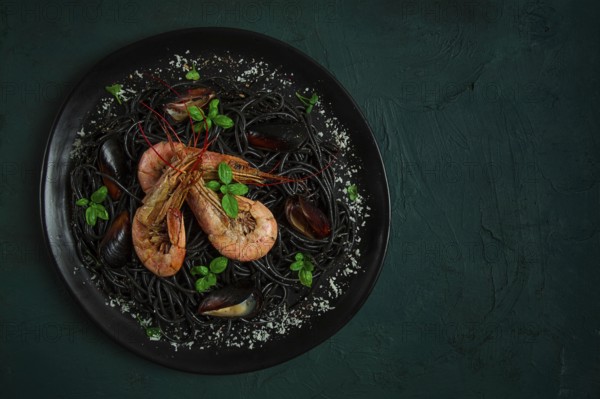 Black pasta with seafood, spaghetti with shrimp and mussels, top view, homemade, no people