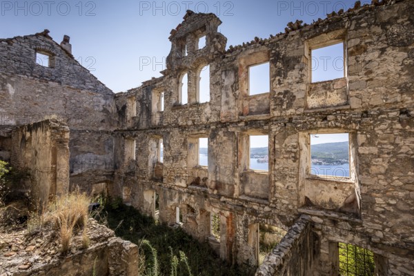 View through the windows of a dilapidated building to the blue sky and the sea, Peljesac, Croatia, Europe