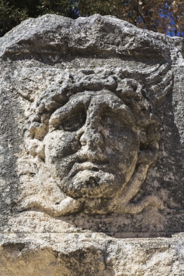 Close-up of sculpted male face on stone wall in the old Croatian public Square, Old Town of Zadar, Croatia, Europe