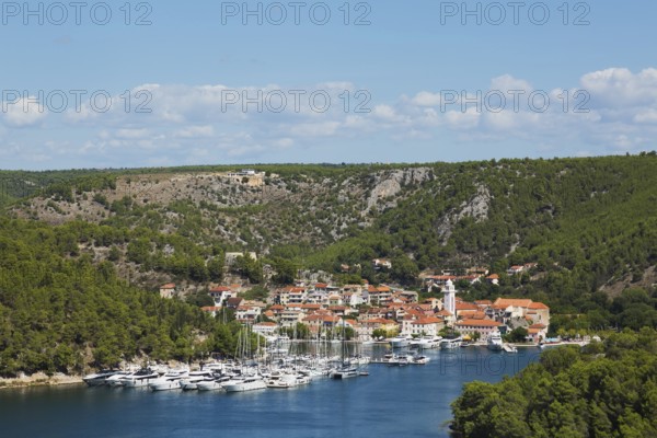 Marina plus commercial and residential buildings with traditional terracotta clay roof tiles in Skaradin town on edge of the Krka river taken from Krka belvedere in late summer, Dalmatian Coast, Croatia, Europe