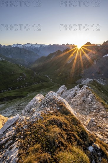 Mountain landscape at sunrise with sun star, view of mountain peaks of the Venediger group and into the Großbachtal valley from the summit of Bachlenkenkopf, Lasörling group, Hohe Tauern National Park, East Tyrol, Tyrol, Austria, Europe