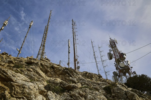 Several radio masts and antennas towering into the cloudy sky on a rocky hill, mountain top, antenna installations, Profitis Ilias, Rhodes, Dodecanese, Greek Islands, Greece, Europe