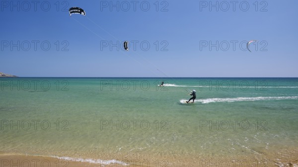 Kitesurfer on turquoise blue sea near the beach under a clear blue sky, surfers paradise, kitesurfer, windsurfer, Prasonisi, island in the south of Rhodes, Rhodes, Dodecanese, Greek Islands, Greece, Europe