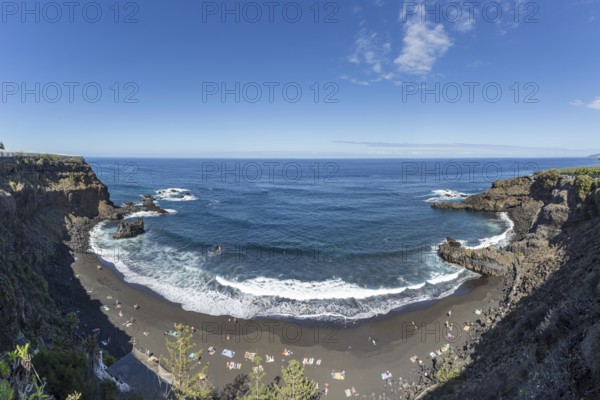 The lava beach lined with bathers, Playa del Bollulo, near Puerto de la Cruz, Tenerife, Canary Islands, Spain, Europe