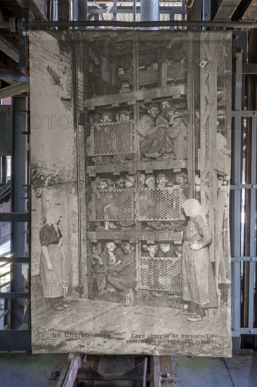 1920s old photograph showing coal miners in coal mining lift cage, elevator at Le Bois du Cazier coal mine museum, Marcinelle, Hainaut, Belgium, Europe