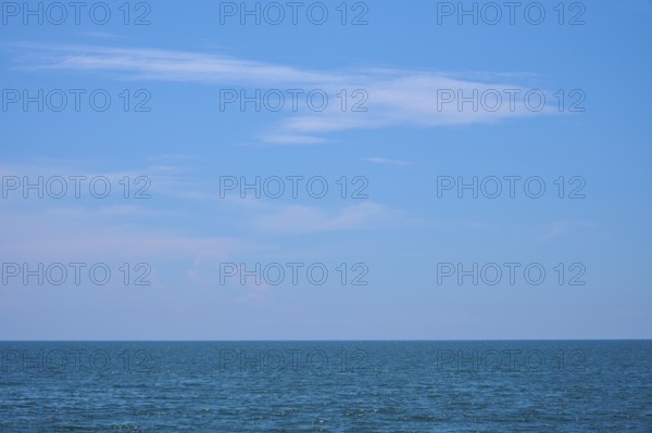 Mediterranean Sea with blue sky, gentle waves and some clouds on the horizon, summer, Saintes-Maries-de-la-Mer, Camargue, France, Europe