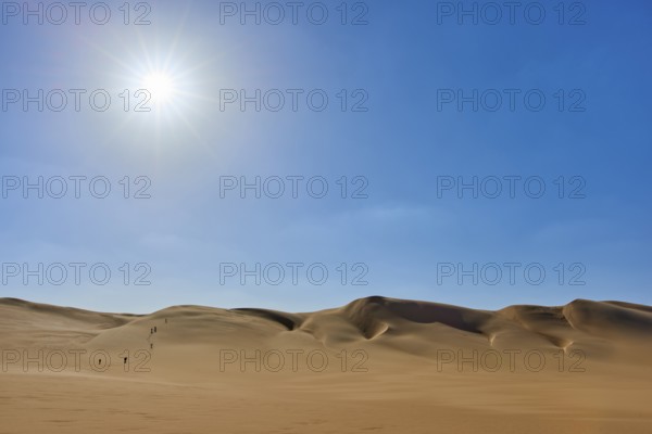 Sunny desert landscape with sand dunes tourist group, under clear blue sky, Matruh, Great Sand Sea, Libyan Desert, Sahara, Egypt, North Africa, Africa