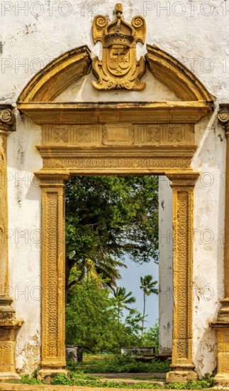 Baroque church portal overlooking tropical vegetation and ruins in the city of Olinda in Pernambuco, Olinda, Pernambuco, Brazil, South America