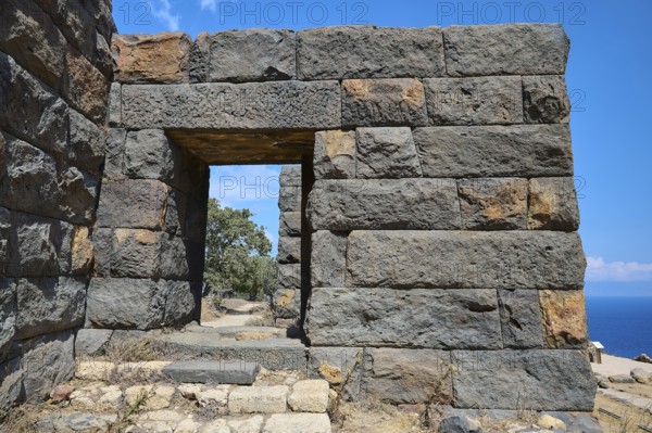 Ancient ruined wall with an archway in an arid landscape overlooking the sea, Palaiokastro, Ancient fortress, 3rd and 4th century BC, above Mandraki, Nisyros, Dodecanese, Greek Islands, Greece, Europe