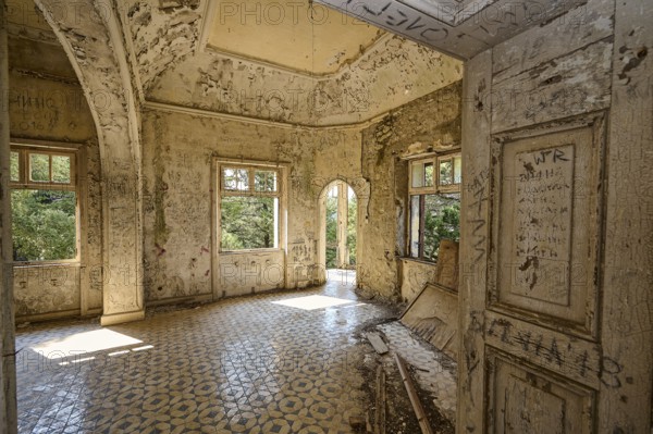 An abandoned room with decorated tiles, an arched entrance and open windows shows clear signs of decay, Mussolini Villa, Villa de Vecchi, Profitis Ilias, Empona, Rhodes, Dodecanese, Greek Islands, Greece, Europe