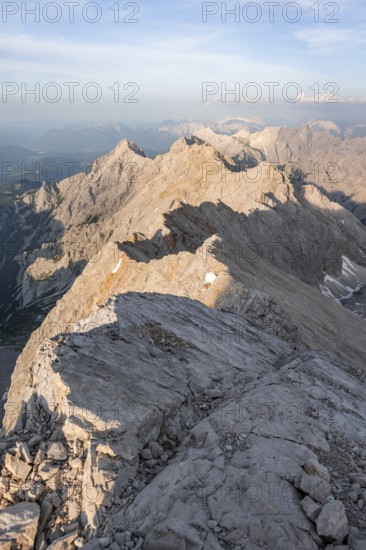 Impressive rocky mountain landscape in the evening light, steep mountain ridge, Jubiläumsgrat with Alpspitze, Zugspitze, Wetterstein range, Bavaria, Germany, Europe