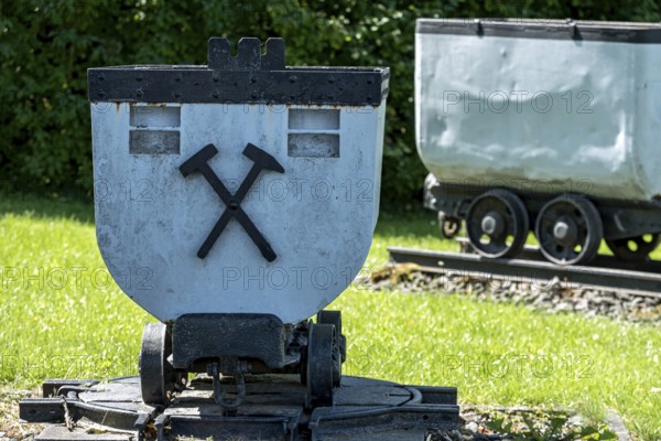 Trolleys for transporting brown coal underground, mining, mine wagon with hammer and iron symbol, wagon, open-air museum at Weckesheim railway station, Reichelsheim, Wetterau, Hesse, Germany, Europe