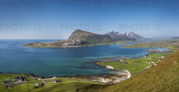 Landscape with sea and mountains, view from Hornsheia to the mountains Offersoykammen and Himmeltindan. Good weather, blue sky. Early summer. Panoramic photo. Hornsheia, Haug, Vestvagoya, Lofoten, Norway, Europe