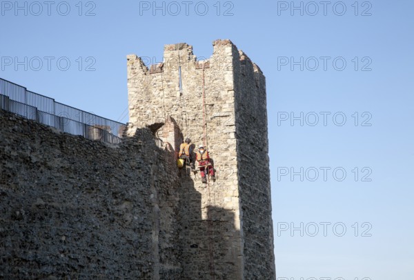 Stonemasons doing maintenance repairs to the stone walls of Framlingham castle, Suffolk, England, United Kingdom, Europe