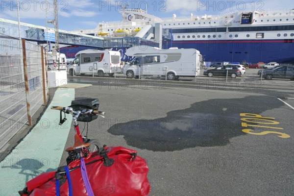 Several motorhomes are parked on a ferry car park, with a large ferry in the background, Transport, Ferry to Norway, Hirtshals, Jutland, Denmark, Europe