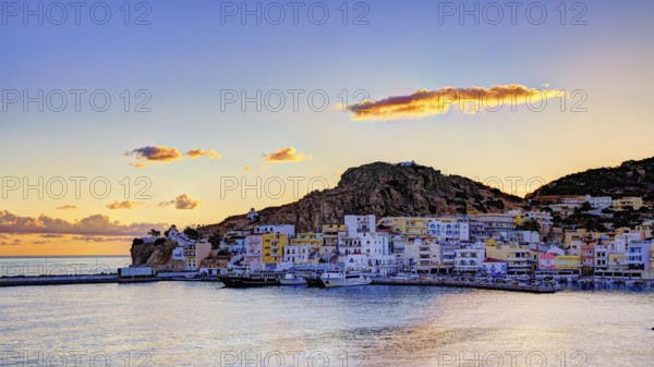 Picturesque coastal town at sunrise with colourful houses, sea and hills in the background, Pigadia, town and harbour, Pigadia Bay, main town, Karpathos, Dodecanese, Greek Islands, Greece, Europe