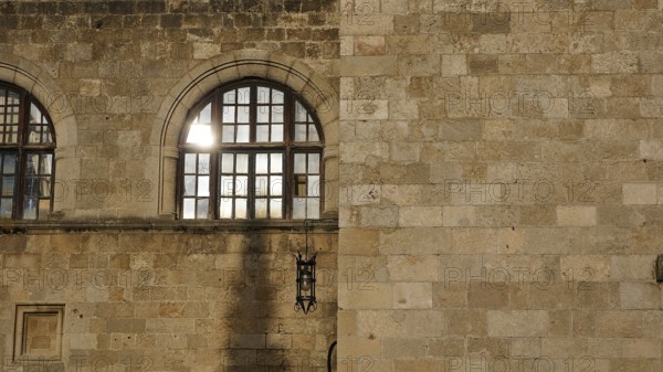 Old hospital, detail of a historic stone wall with windows and a lantern, showing Mediterranean architecture, Rhodes Old Town, Rhodes Town, Rhodes, Dodecanese, Greek Islands, Greece, Europe