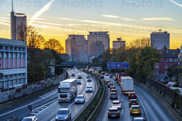 Evening traffic, partly with traffic jams, slow-moving traffic on the A40 motorway, skyline of Essen, RWE tower on the left, Evonik Group headquarters in the middle, former Postbank building on the right, Essen, North Rhine-Westphalia, Germany, Europe