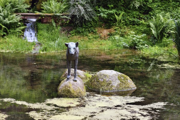 Heidelberg, Germany, June 8th 2024: Wolf sculpture at historic well called 'Wolfsbrunnen' in Heidelberg Schlierbach, Europe