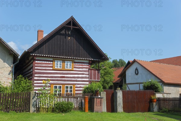 A traditional wooden house with residential facilities and a garden surrounded by a wooden fence, Old wooden house, Vesec u Sobotky, village conservation area, Libošovice, Libosovice, Okres Jicín, Hradec Králové, Czech Republic, Europe