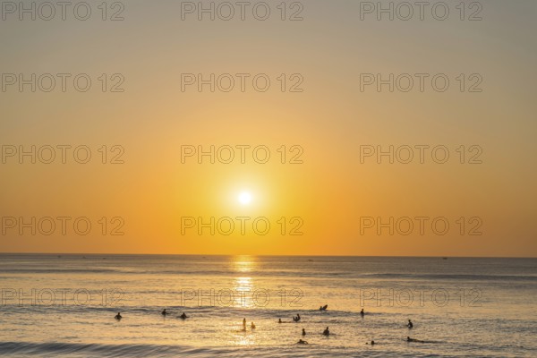 Surfer in the sea, beach, holiday, sunset, travel, beach holiday, tourism, evening sun, evening mood, relaxed, relaxing, sunshine, beautiful, weather, evening sky, sea, Pacific Ocean, beach holiday, long-distance trip, sun, afternoon, tourist, sandy beach, dream holiday, holiday cliché, holiday, summer holiday, holiday time, water, water sports, destination, Dream beach, Uluwutu, Bali, Indonesia, Asia