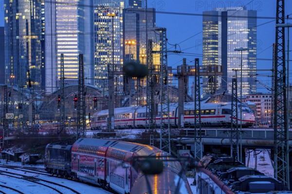 Railway tracks in front of the main station of Frankfurt am Main, ICE train, skyline of the skyscrapers in the Cit, winter, snow, dusk, Hesse, North Rhine-Westphalia