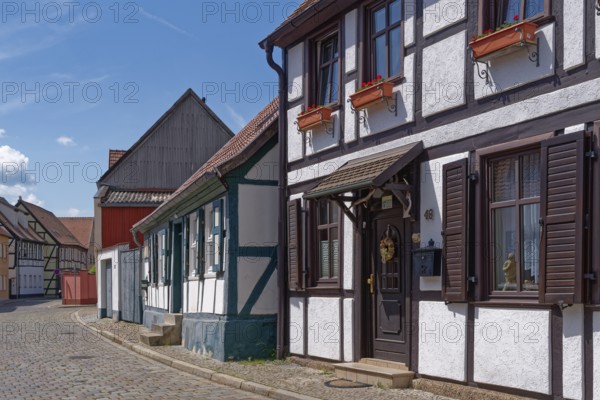 Half-timbered houses in the Lange Fischerstraße, covered with cobblestones, in the old town of Tangermünde, Hanseatic town in the Altmark. Saxony-Anhalt, Germany, Europe