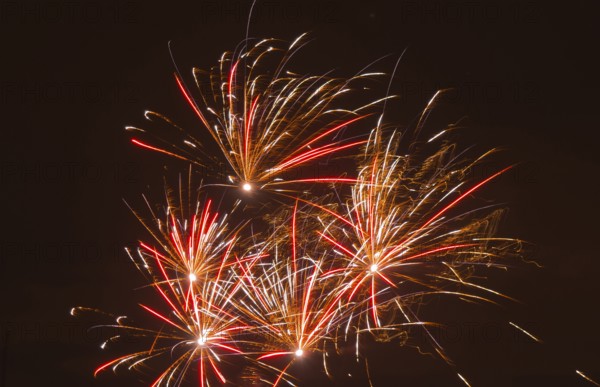 Fireworks with red and yellow sparks that glow in the dark, Lower Saxony, Germany, Europe