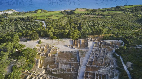 Drone shot, first morning light, aerial view of ancient ruins near the coast, surrounded by green fields and vegetation, Kamiros, Archaeological site, Ancient city, Foundation of Doric Greeks, Rhodes, Dodecanese, Greek Islands, Greece, Europe