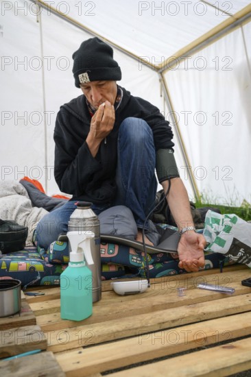 Wolfgang Metzeler-Kick having his body temperature and blood pressure measured on the 78th day of his hunger strike. Hunger strike camp, Invalidenpark, Berlin, 23.05.2024