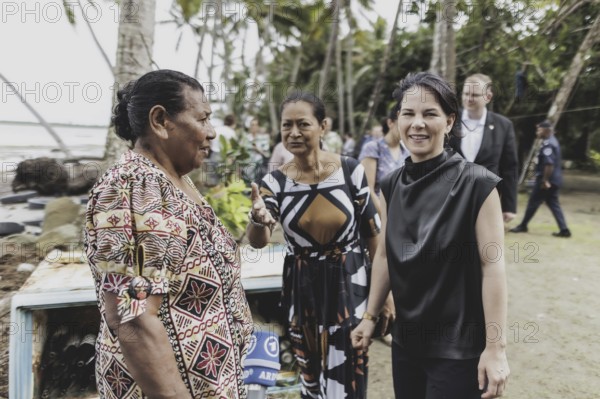 (R-L) Annalena Bärbock (Bündnis 90/Die Grünen), Federal Foreign Minister, Christine Fung, employee of the Deutsche Gesellschaft für Internationale Zusammenarbeit, and Lavenia McGoon, resident of the Togoru settlement, photographed during a briefing on coastal erosion at a cemetery near the Togoru settlement flooded by rising sea levels, 07.05.2024. Bärbock is travelling to Australia, New Zealand and Fiji for political talks / Photographed on behalf of the Federal Foreign Office