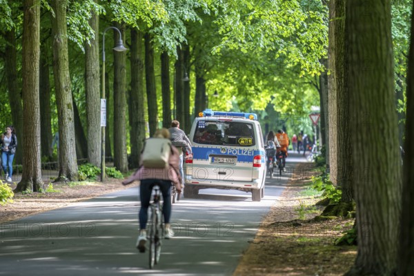 Police patrol on the Promenade cycle path, a tree-lined, car-free, approximately 4.5 km long ring road around the city centre of Münster, North Rhine-Westphalia, Germany, Europe