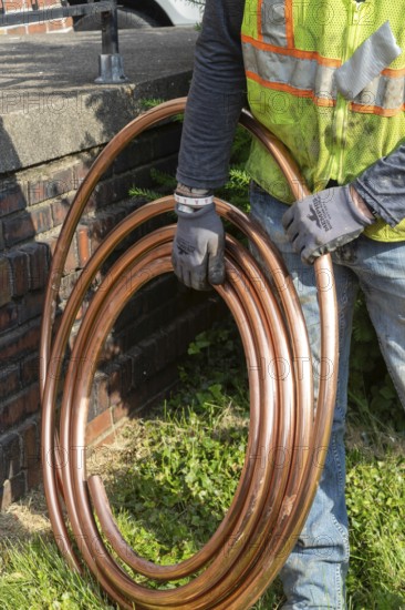 Detroit, Michigan, Workers replace old lead water service lines with copper pipes. Lead is harmful to health, especially in children. The city of Detroit estimates there are 80, 000 homes in the city with lead service lines and has begun a program to replace them all