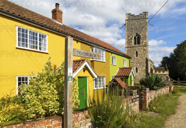 Historic cottages next to village parish church of All Saints, Rede, Suffolk, England, UK