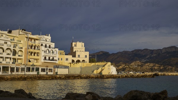 Coastal town in the morning light with buildings and mountains in the background, Pigadia, town and harbour, Pigadia Bay, main town, Karpathos, Dodecanese, Greek Islands, Greece, Europe