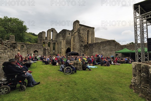 Visitors at an open-air concert in the evening, ruin, Abbey Farm, Llangollen, North Wales, Wales, Great Britain