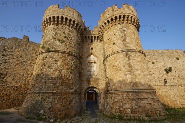 Stone castle wall with two towers and battlements in daylight, sea gate, harbour area, Rhodes Town, Rhodes, Dodecanese, Greek Islands, Greece, Europe