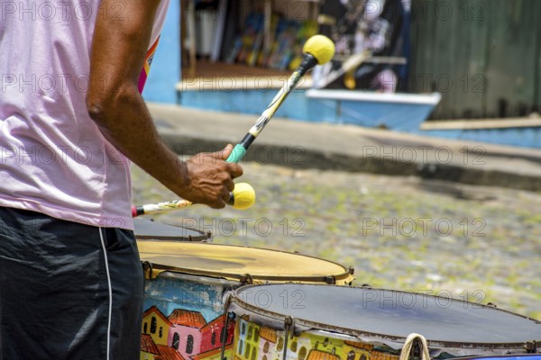 Drummer with colorful drums on the slopes of Pelourinho in the city of Salvador, Bahia, Pelourinho, Salvador, Bahia, Brazil, South America