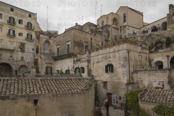 Historic Italian town view with old stone buildings and narrow streets under a grey sky, old town Matera, Basalicata, Southern Italy, Italy, Europe