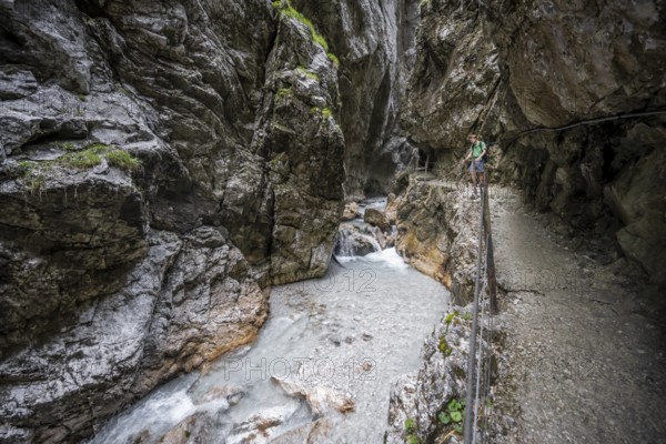 Hammersbach mountain stream in a canyon, mountaineer on a hiking trail in a gorge, Höllentalklamm, Höllental, Bavaria, Germany, Europe