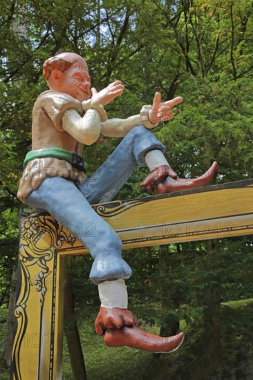 Sculpture for the fairy tale The Brave Little Tailor, fairy tale figure, gesture, arms, sitting, castle park, castle, Lichtenwalde, Niederwiesa, Saxony, Germany, Europe