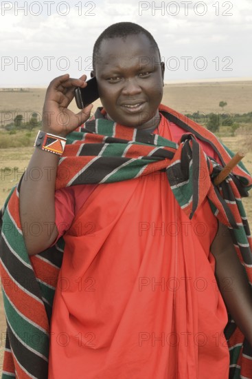 Maasai on the phone, Massai Mara, Enkutoto, Serengeti, Rift Valley province, Kenya, Africa